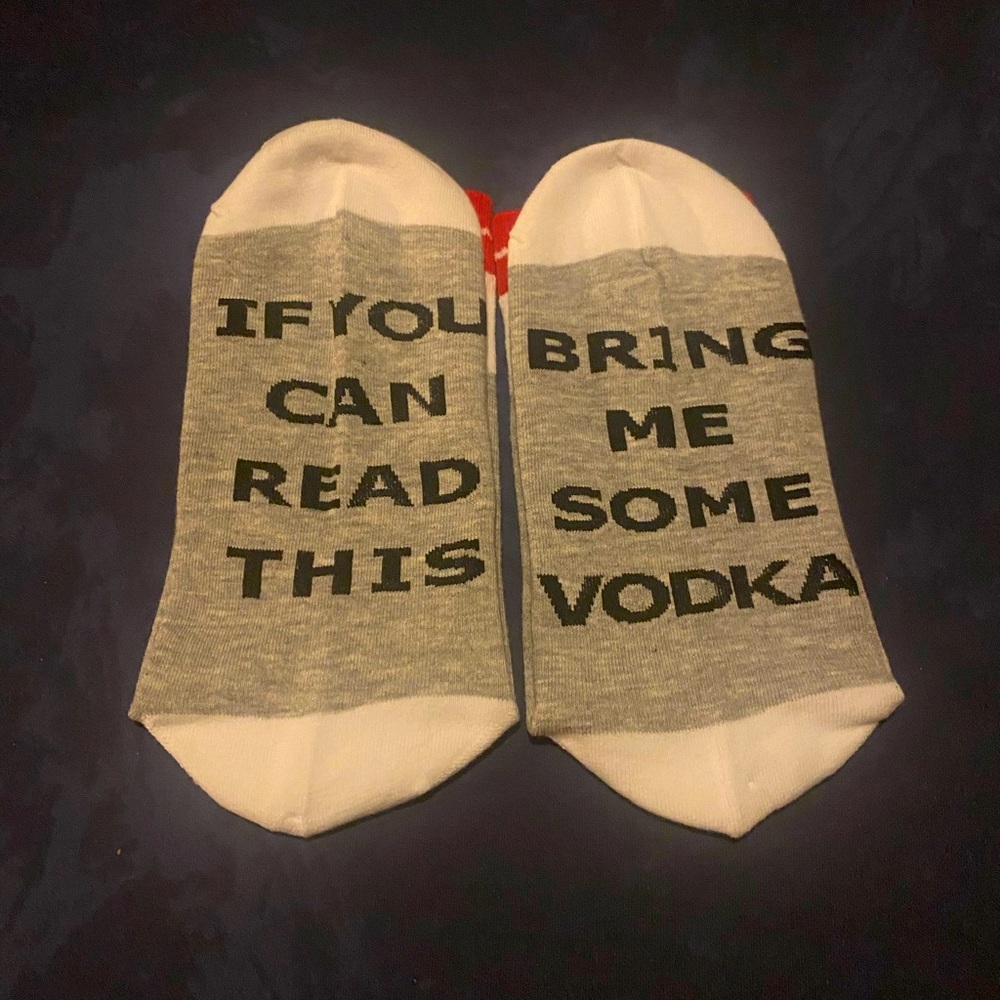 NWOT Sock slogans. Grey, white with red band at the top of sock.